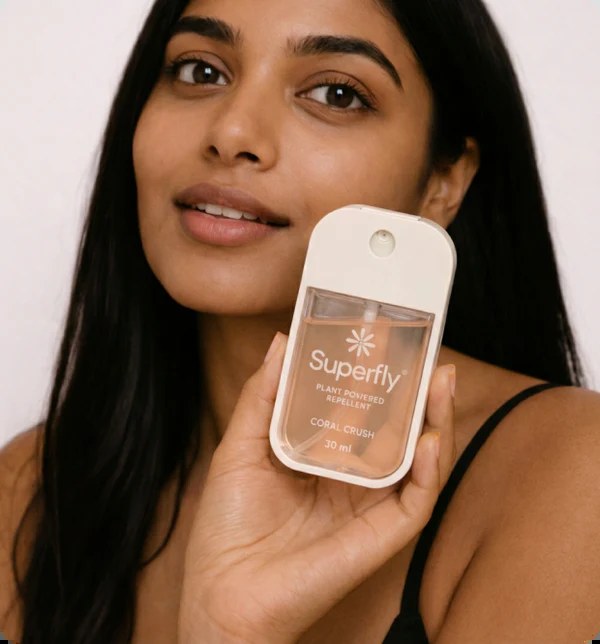 Woman holding Superfly Coral Crush bottle